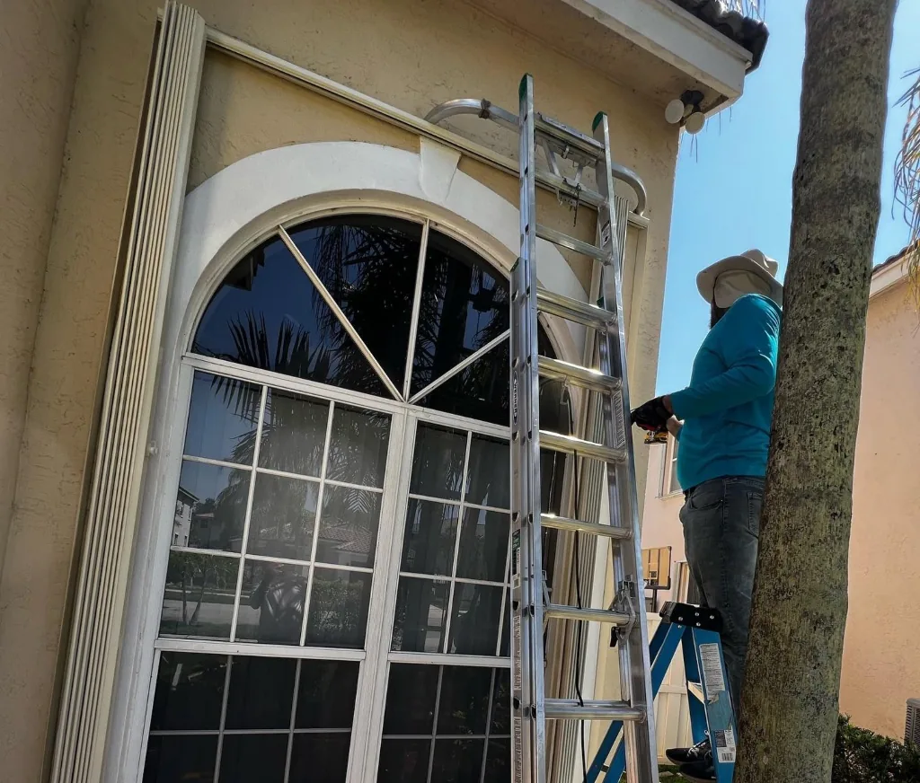 Accordion shutters installed around arched window