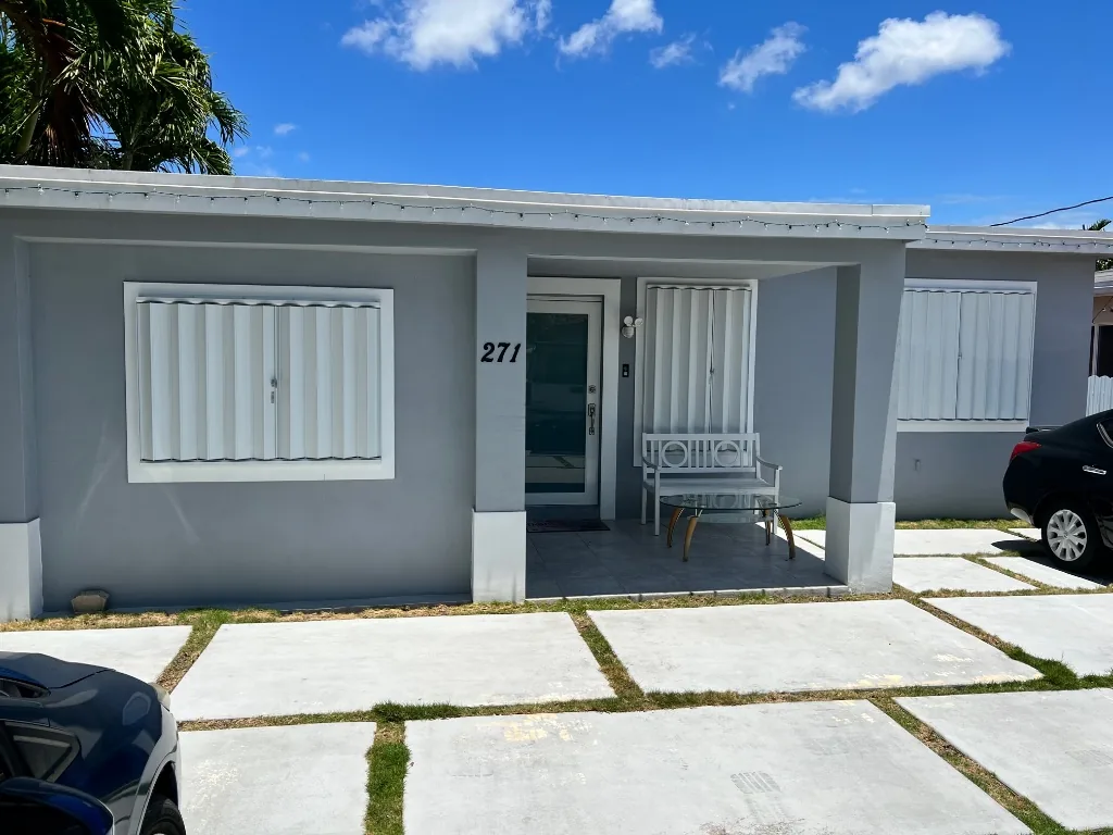 Accordion shutters installed on front windows of a Miami home